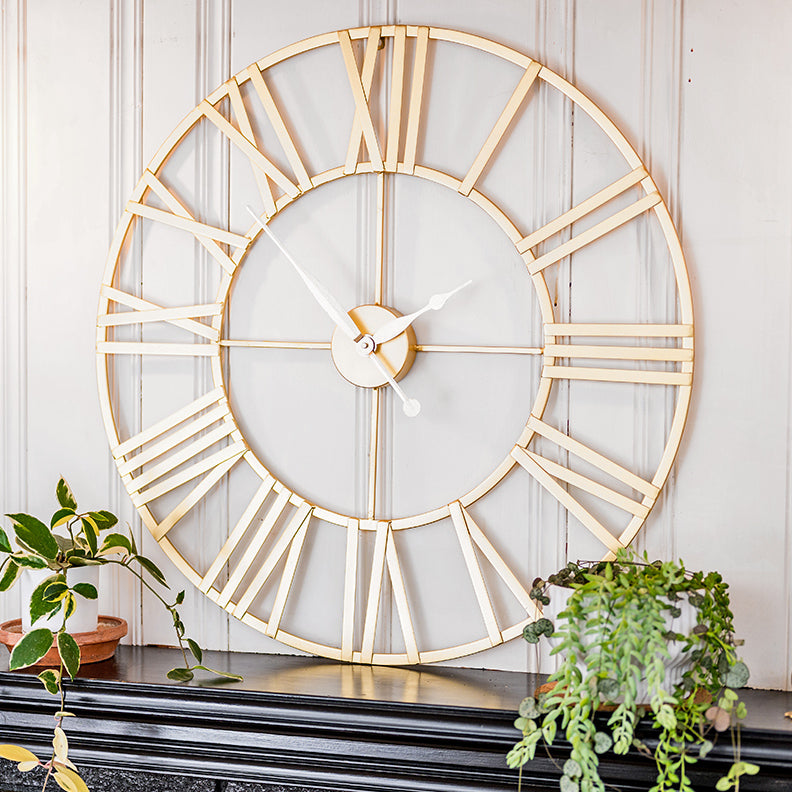 Anya, gold tone, minimalist round wall clock featuring Roman numerals