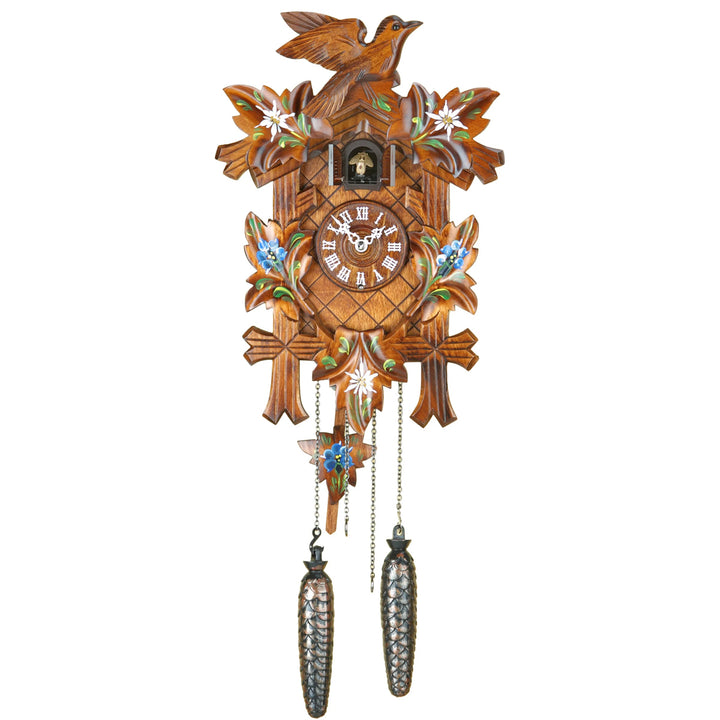 Wooden cuckoo clock with decorative elements on a white background