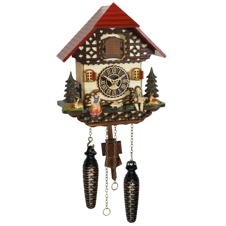 Decorative cuckoo clock with wooden house design on a white background