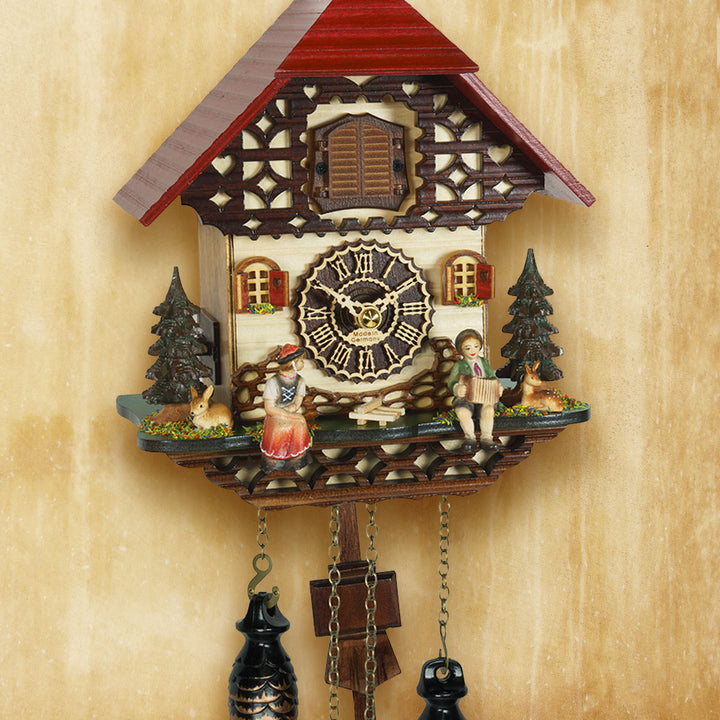 Decorative cuckoo clock with intricate details on a beige background