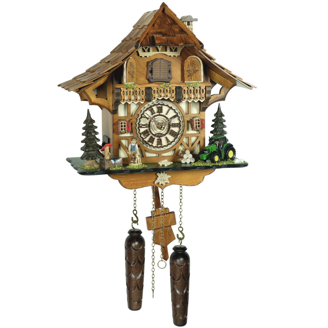 Wooden cuckoo clock with detailed design on a white background