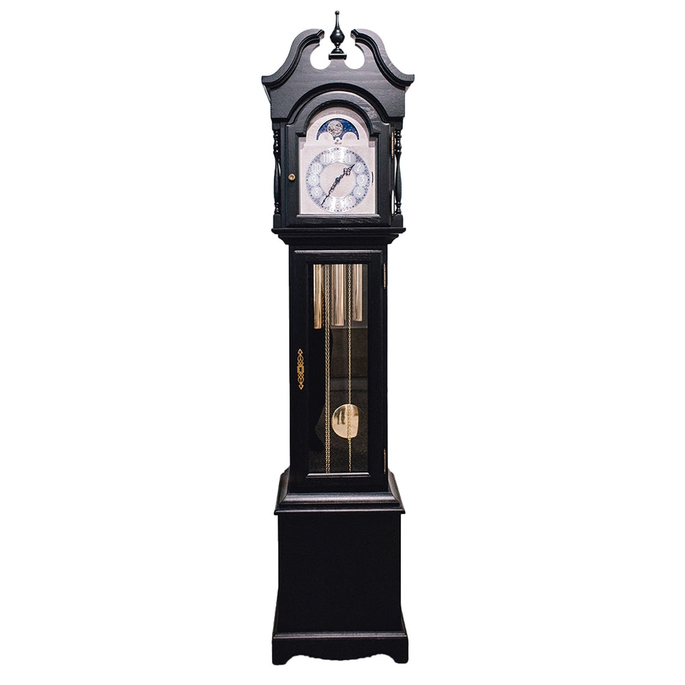 Black finish wood Grandmother clock with brass highlights and silver face on white 