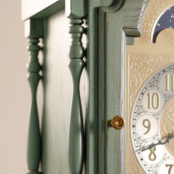 Detailed carved wood on green Grandmother clock