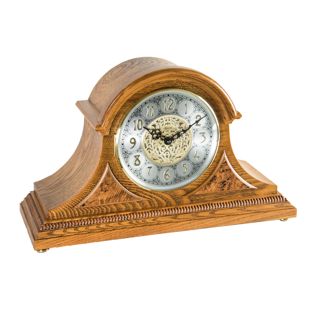 Light oak wood mantle clock with intricate face on white background