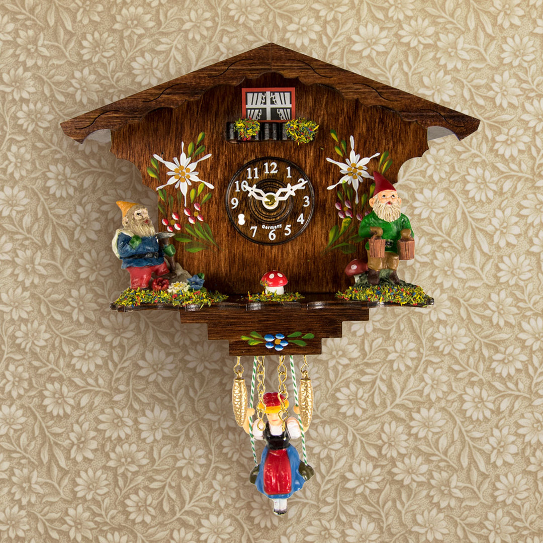 traditional german style cuckoo clock with gnomes and girl on swing 