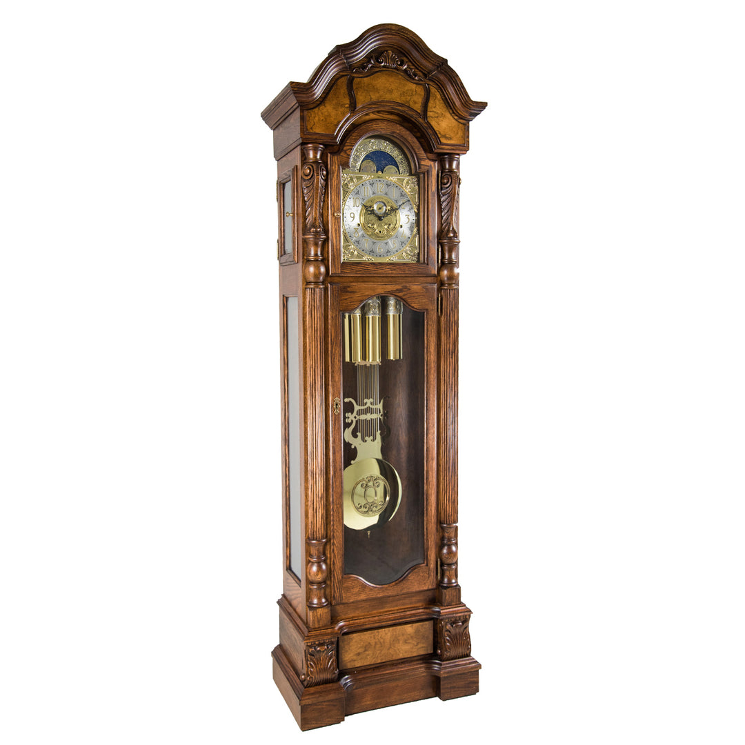Oak wood grandfather clock with detailed brass design on a white background