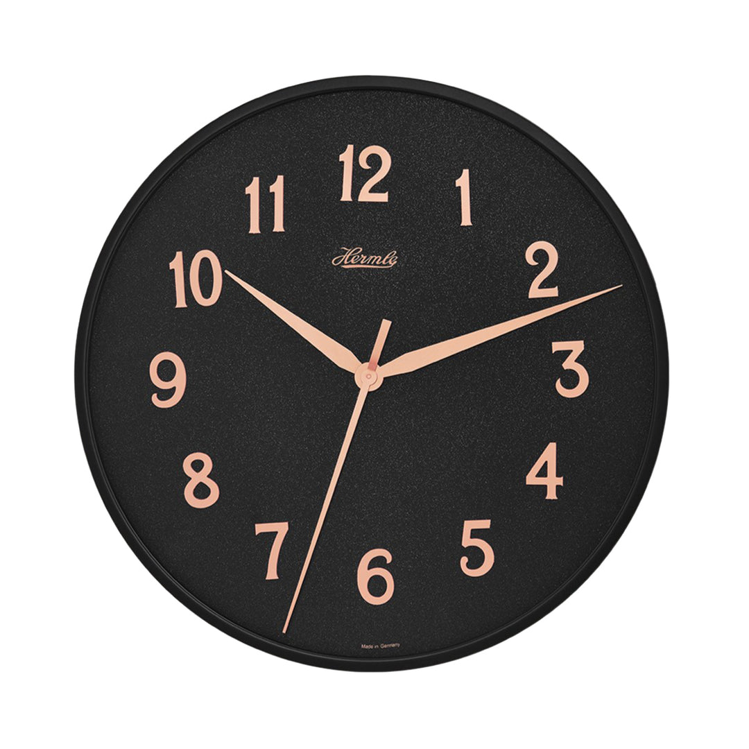 Wall clock with black face and gold numbers with Hermle logo on white background.