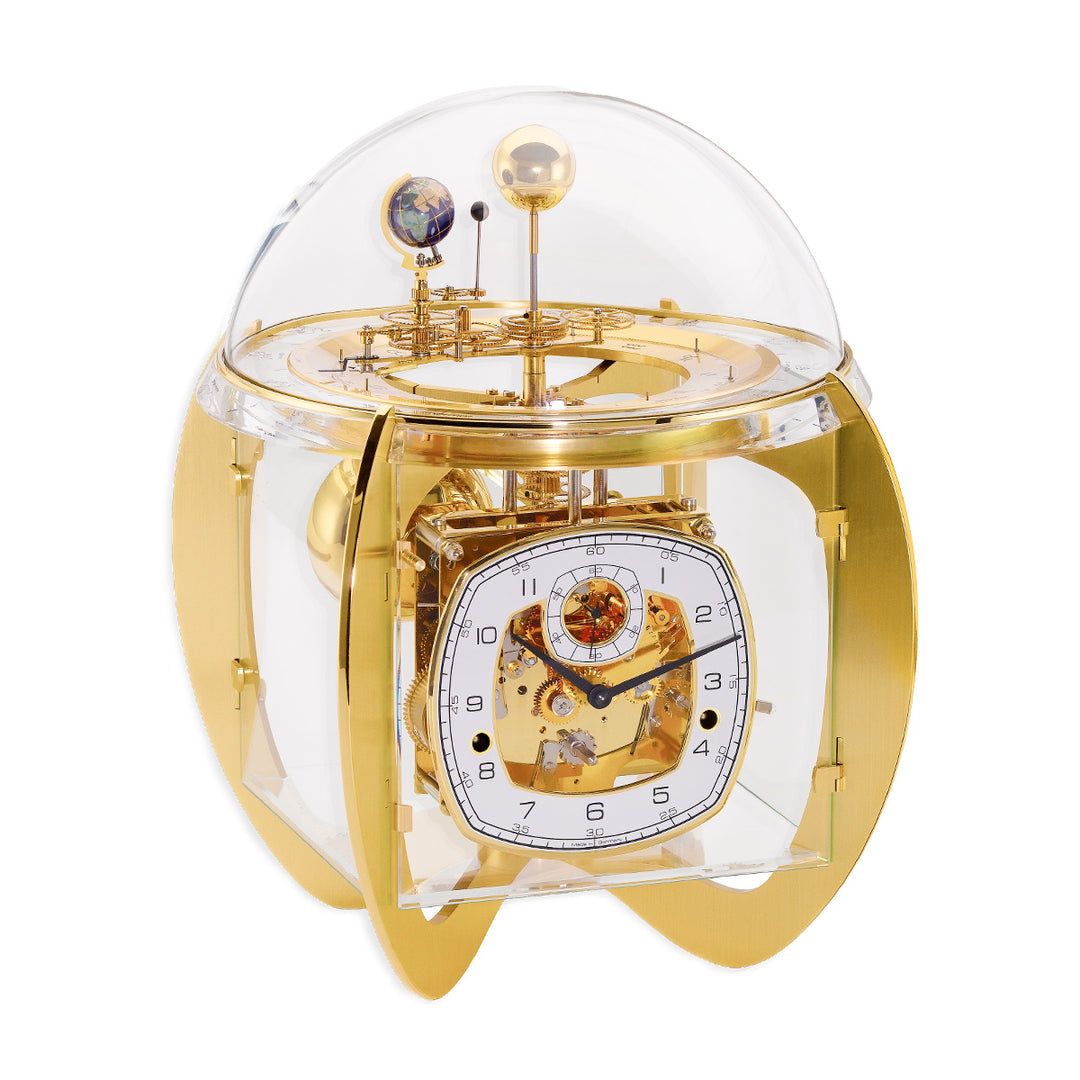 Gold astronomical clock with visible intricate gears and glass dome on white background.