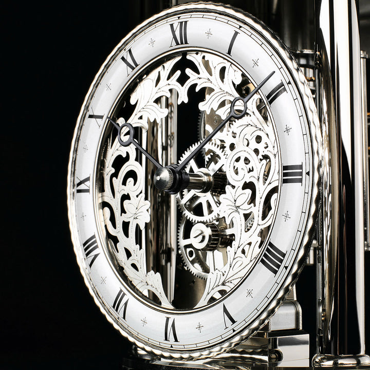 Close-up of nickel Astrolabium clock face with Roman Numerals and leaf scrollwork