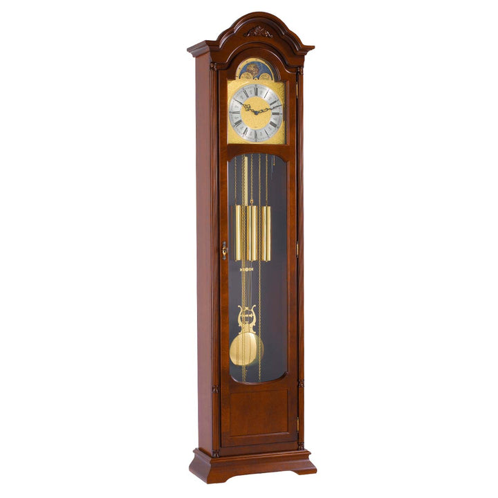 Walnut Grandfather clock with brass face and pendulum on white background