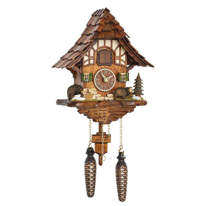 Ornate wooden cuckoo clock with bear figurines and pine tree on white background.
