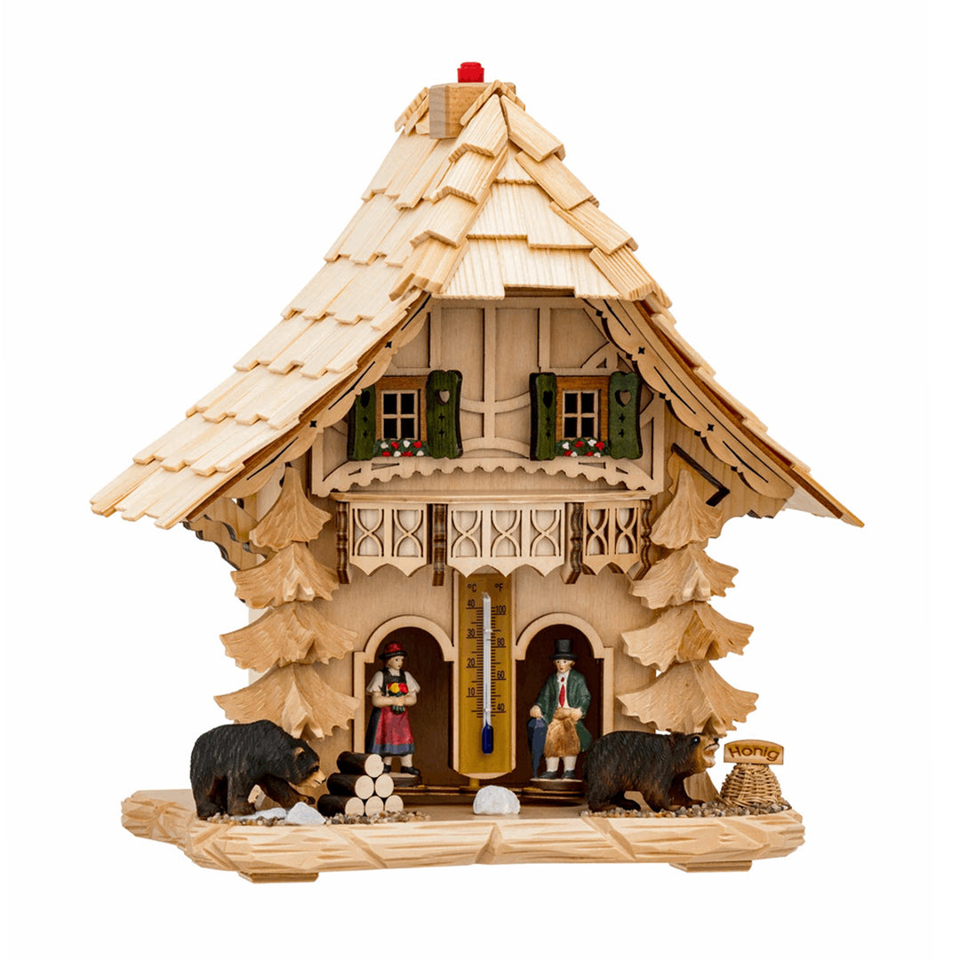 Light wood cuckoo-styled weather station with green shutters thermometer on white background.