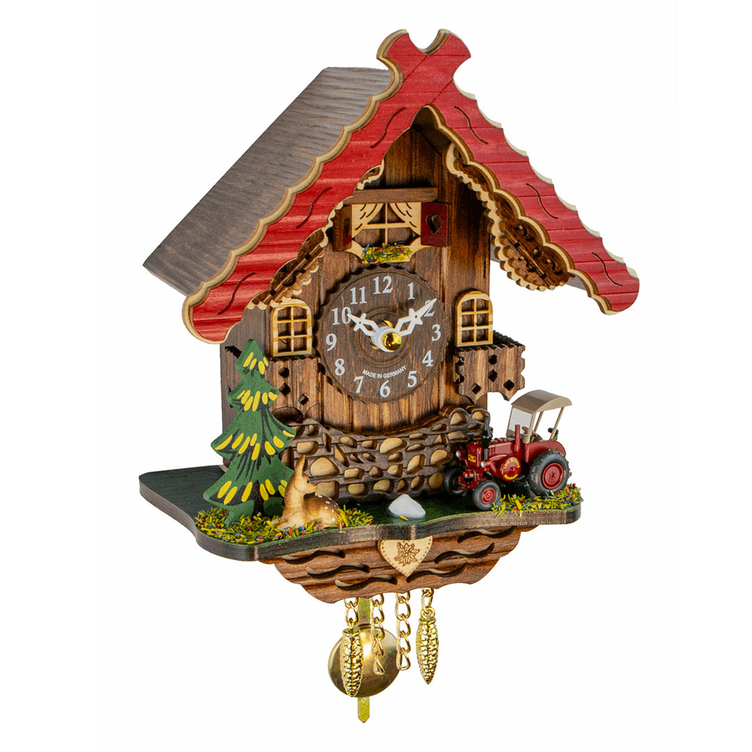 Red trimmed wooden cuckoo clock with red tractor on white background.