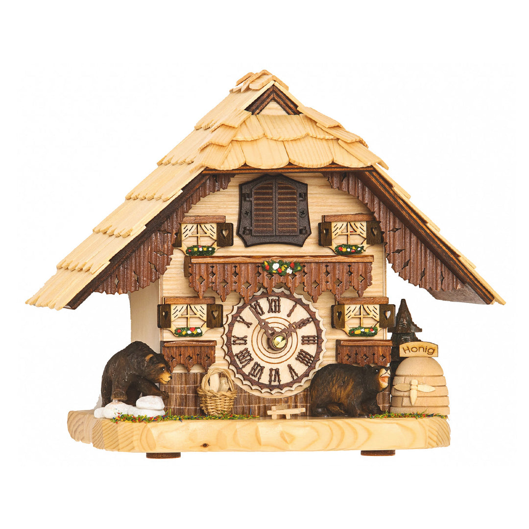Ornate wooden cuckoo clock with bear figures and painted flowers beneath faux windows on white background.
