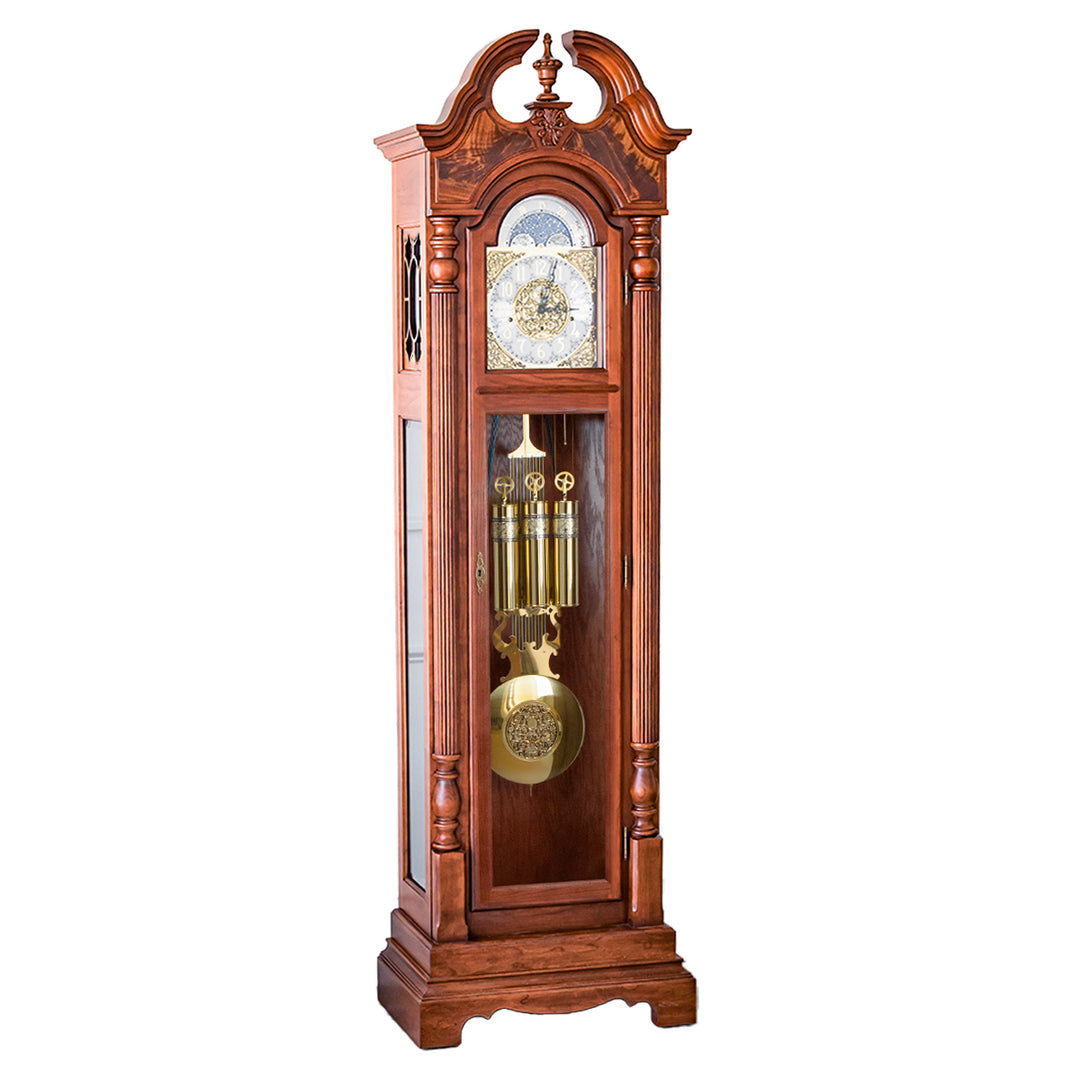 Cherry wood Grandfather clock with ornate design and brass highlights on white background.