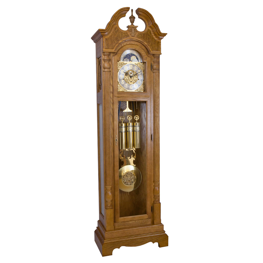 Dark oak wood Grandfather clock with ornate design and brass highlights on white background