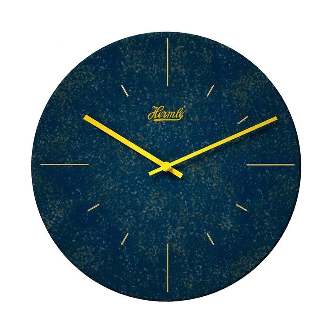 Dark blue patterned wall clock with yellow hands and Hermle logo on what background.