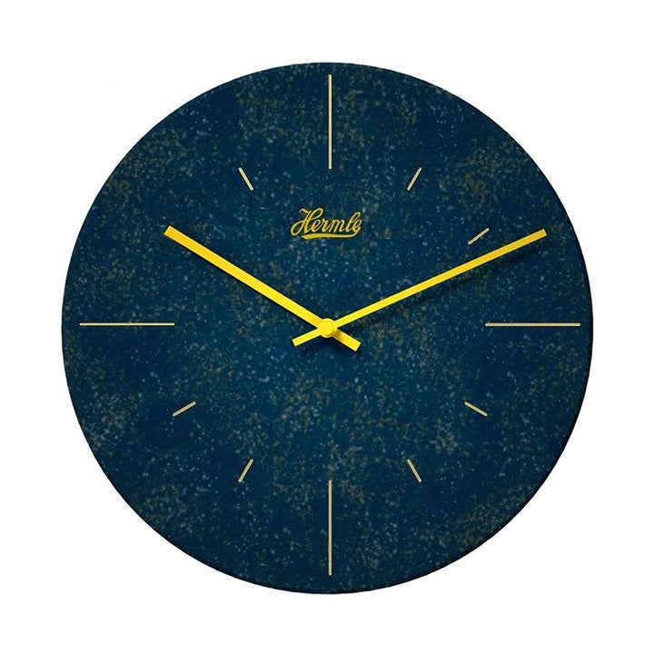 Dark blue patterned wall clock with yellow hands and Hermle logo on what background.