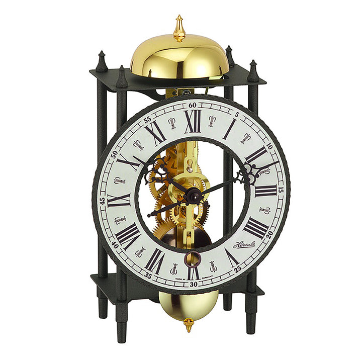 Black mantel skeleton clock with visible brass gears and bell.