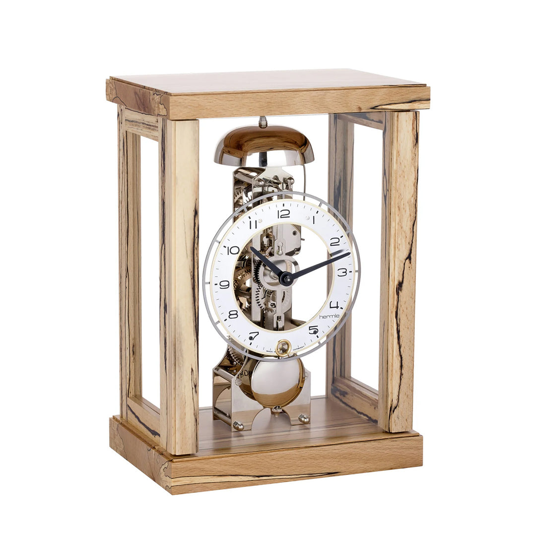 Beech wood mantel clock with visible nickel gears and bell on white background.