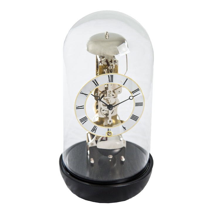 Black mantel clock with glass dome and visible nickel gears on white background.