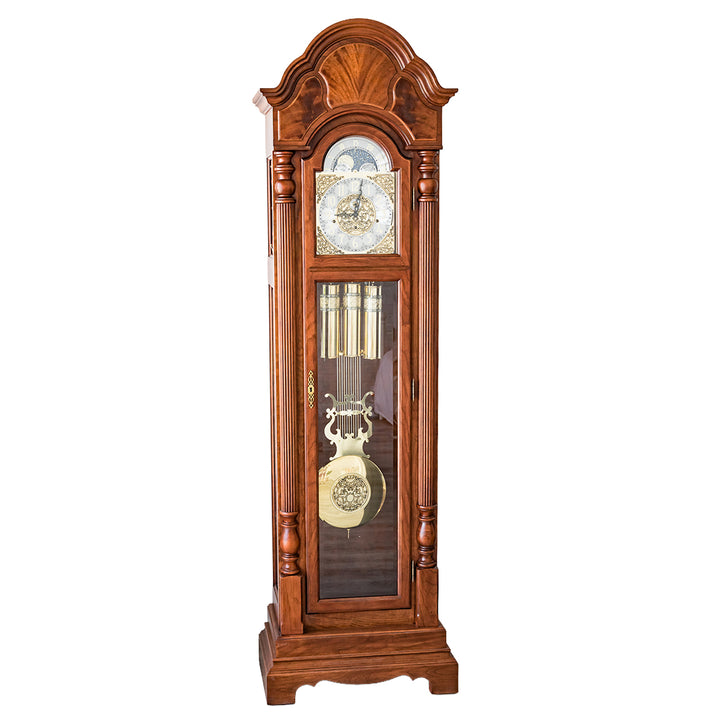 Wooden grandfather clock with brass highlights on a white background