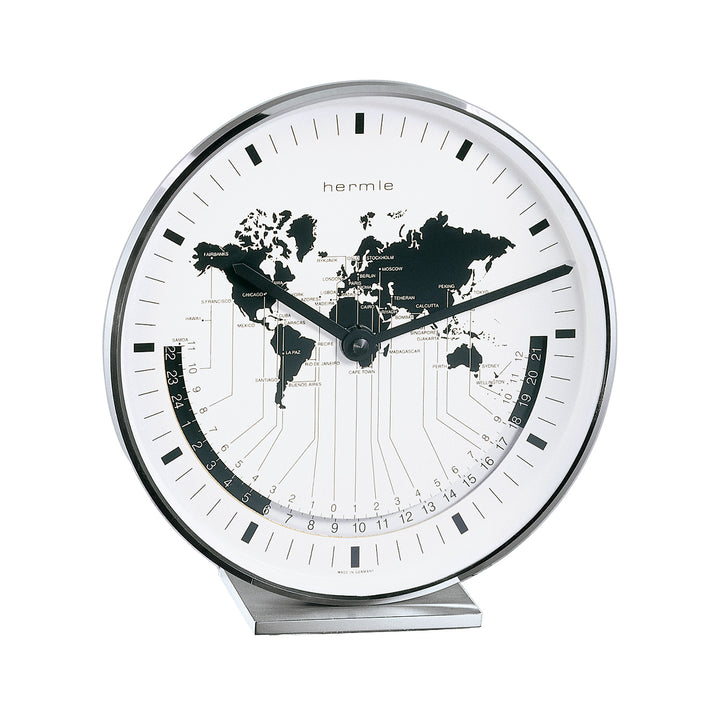 Nickel desk clock on white background with black hands and world map on face.