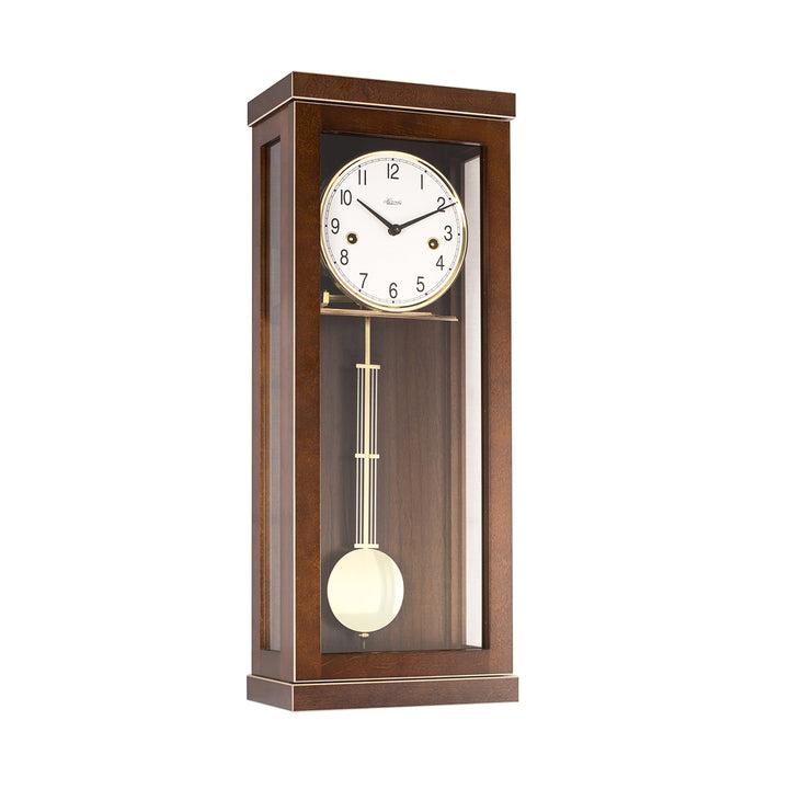 Walnut wood wall clock with pendulum and gold highlights on a white 