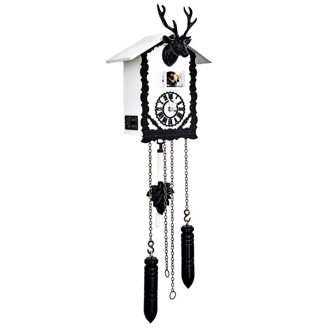 Black and white cuckoo clock with intricate design and decorative deer head