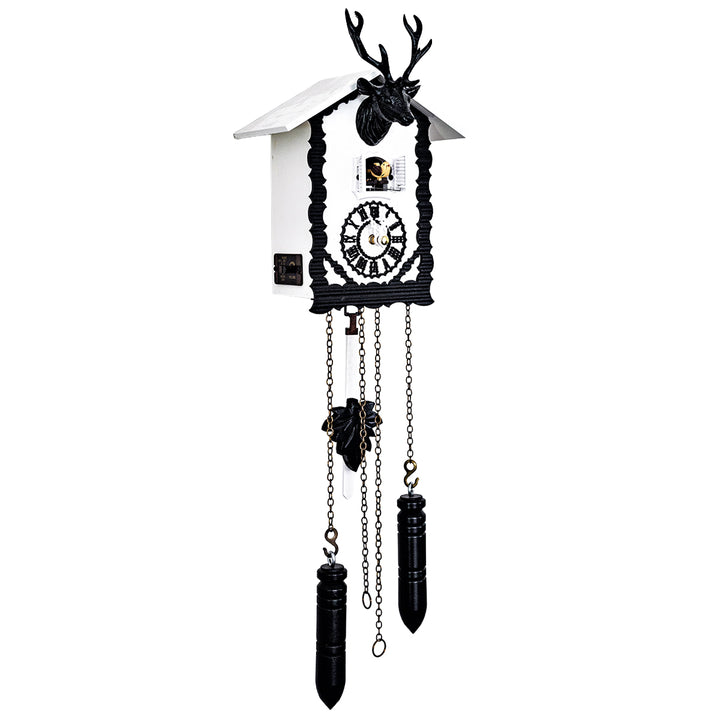 Black and white cuckoo clock with intricate design and decorative deer head