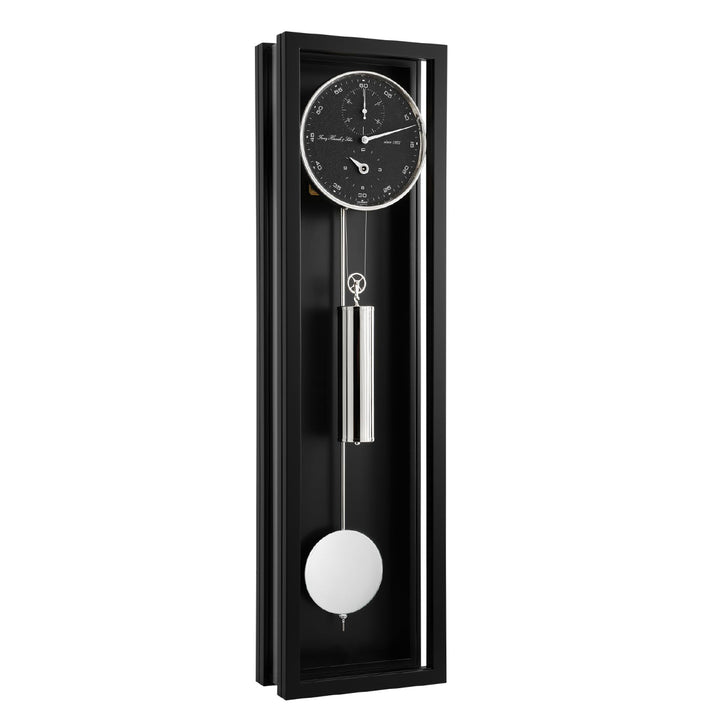 Black wall clock with black face and silver pendulum on a white background