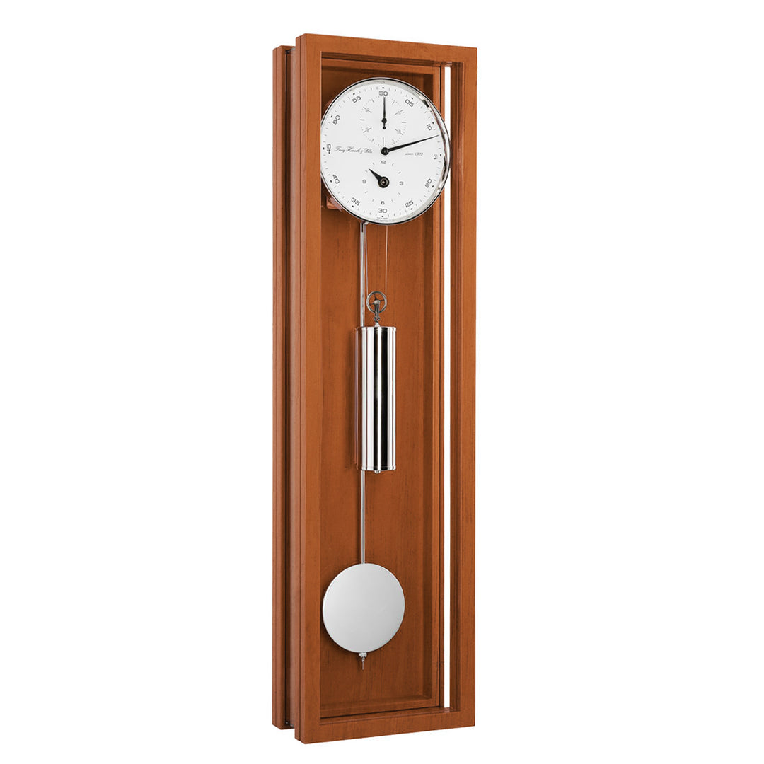 Cherry wood wall clock with pendulum on a white background