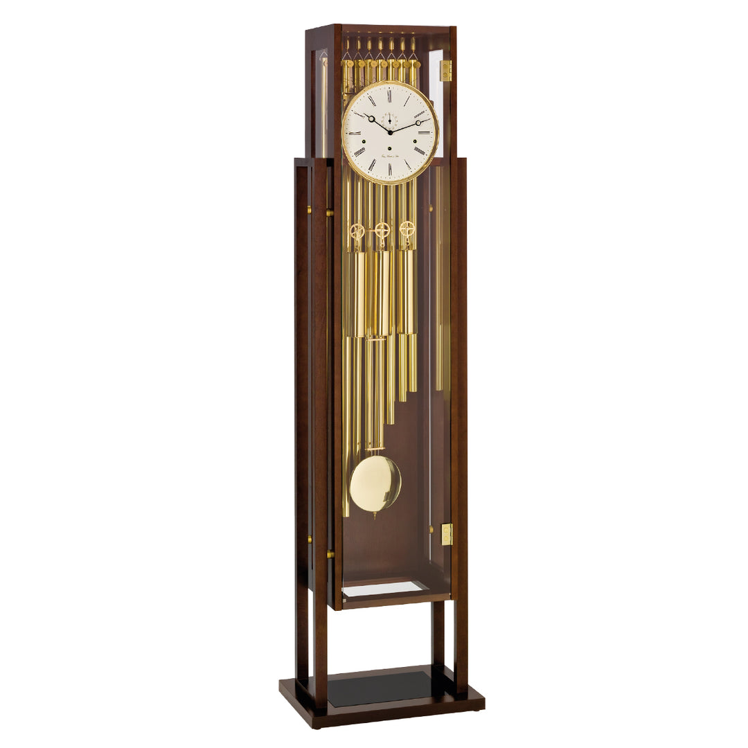 Tubular floor clock with brass highlights and white roman numeral face on white background