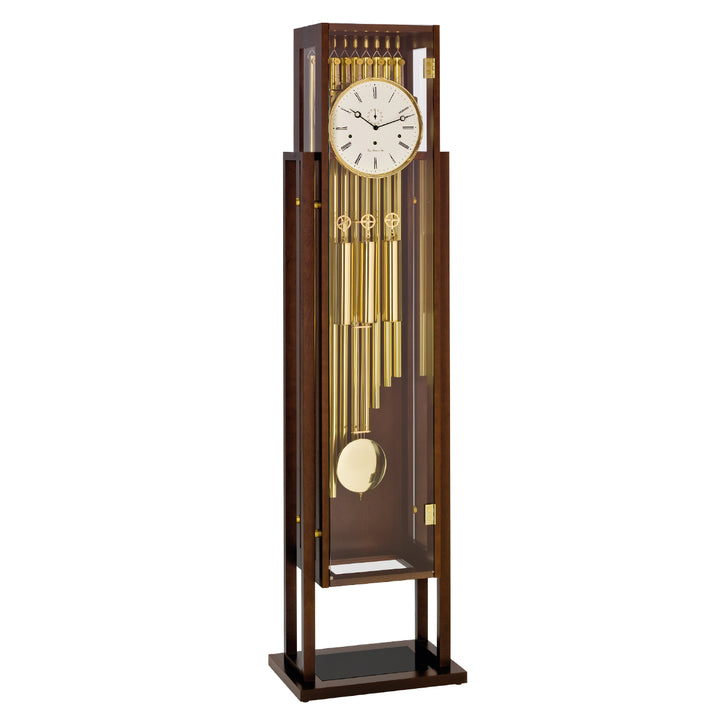 Tubular floor clock with brass highlights and white roman numeral face on white background