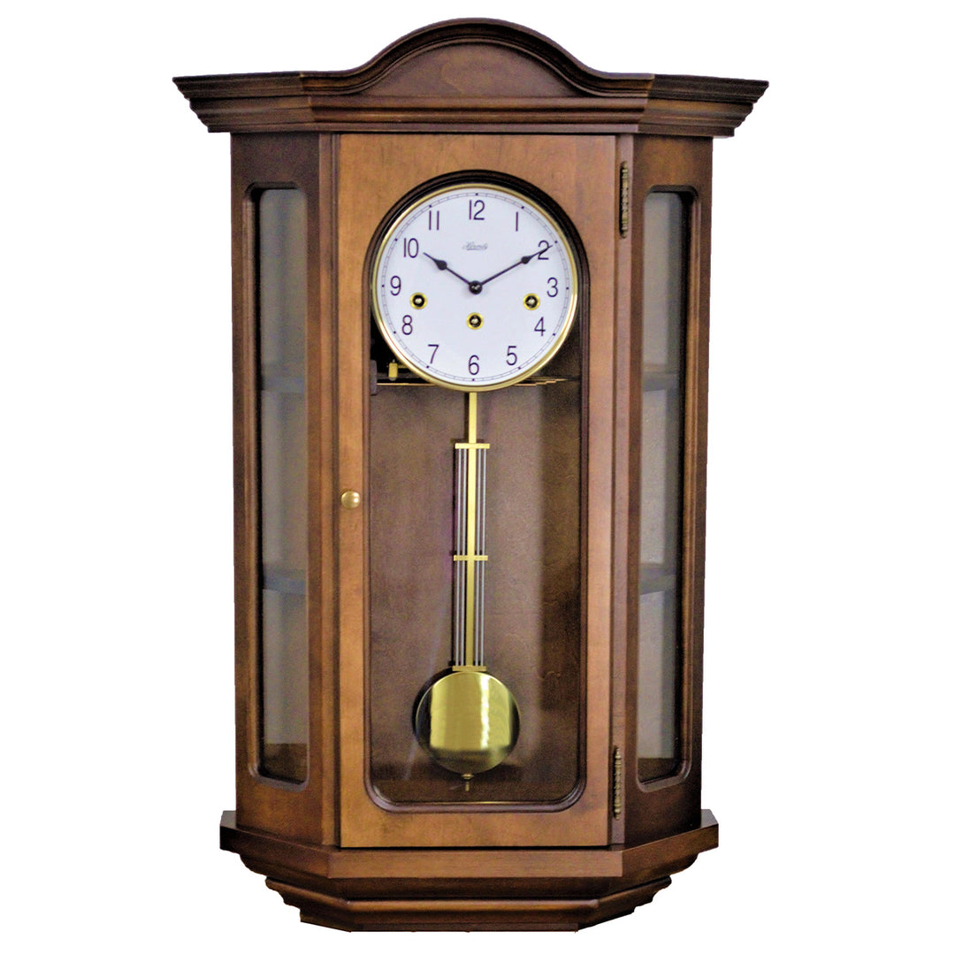 Decorative cherry wood clock with angled glass sides and brass highlights on a white background