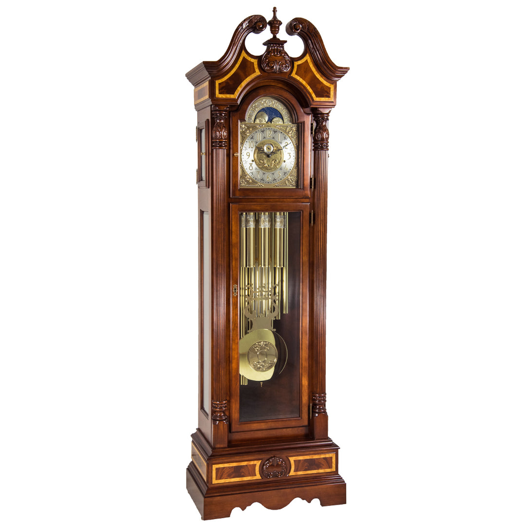 Wooden grandfather clock with intricate design, tubular chime movement and brass pendulum on a white background