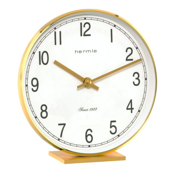 Brass desk clock with bold numbers and brass hands on white background.