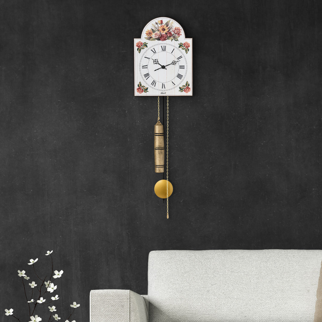 Floral pattern wall clock with roman numeral face hanging on gray wall above sofa in living room.