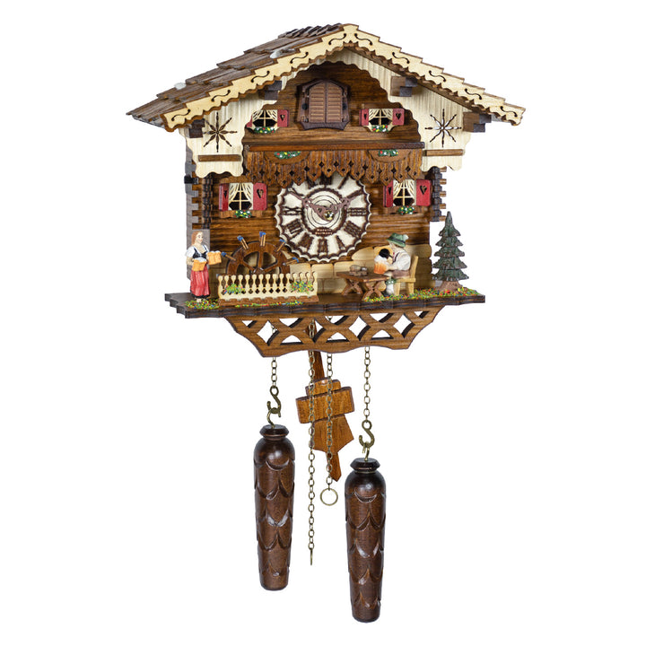 Intricately detailed wooden German cuckoo clock with house style, small figurines and roman numeral face