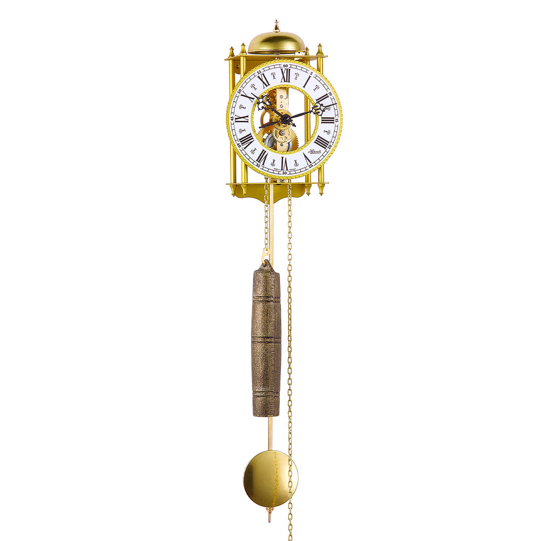 Brass skeleton clock with bell, visible gears and roman numeral face on white background.