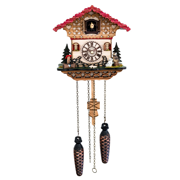 Detailed wooden cuckoo clock with red roof and small owl figures beside a roman numeral face