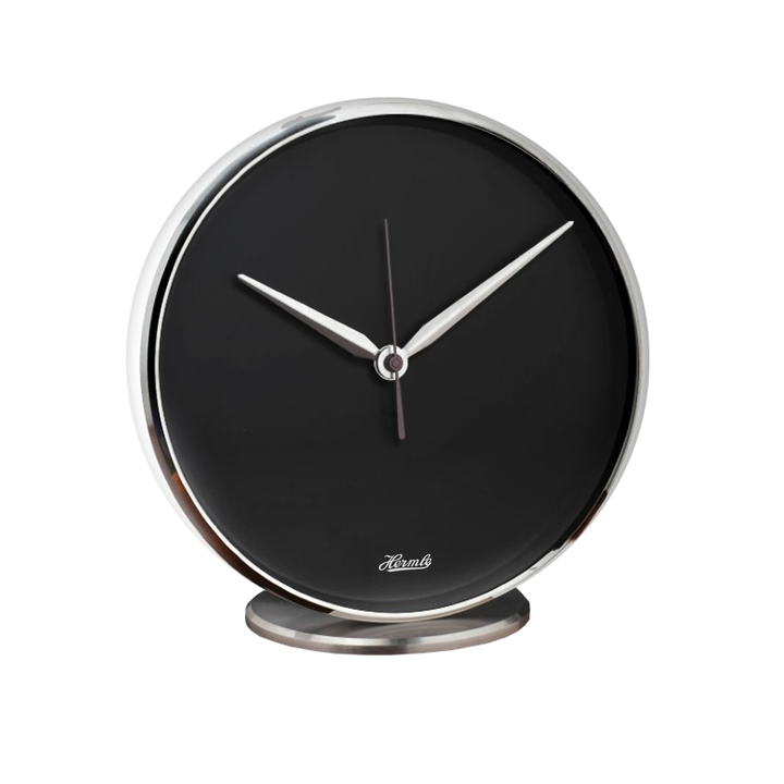Round desk clock with black dial and metallic rim on a white background.