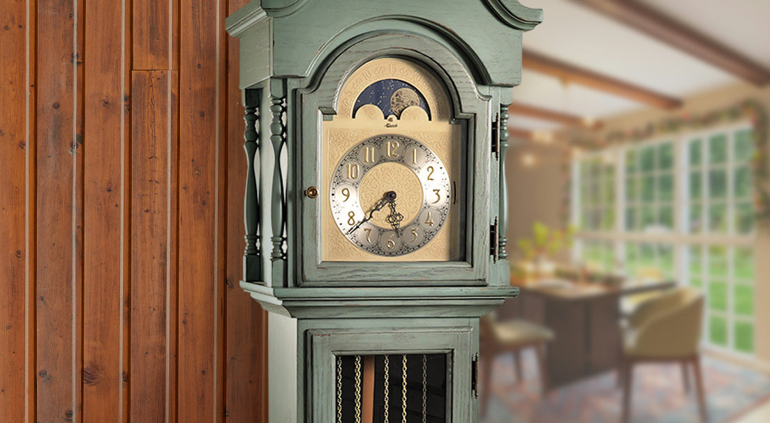 Stylish grandfather clock by wooden wall and dining room scene. Heirloom clock by Hermle.