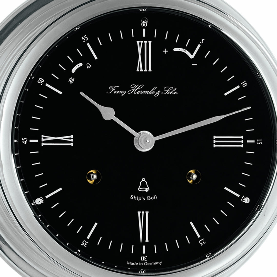 Classic ship's bell clock in nickel with black dial, by Hermle - closeup of clock dial.