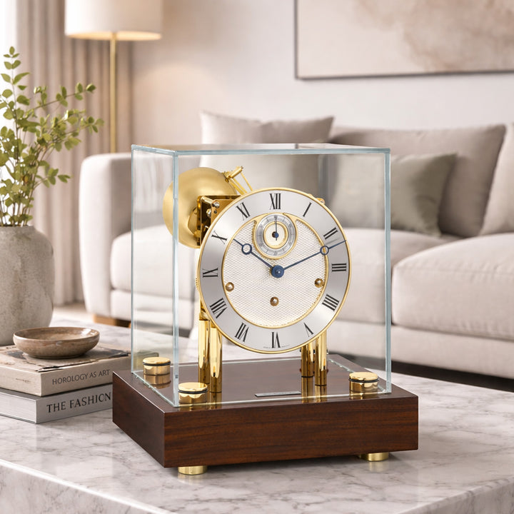 Brass and walnut luxury desk clock with glass cube enclosure in living room scene