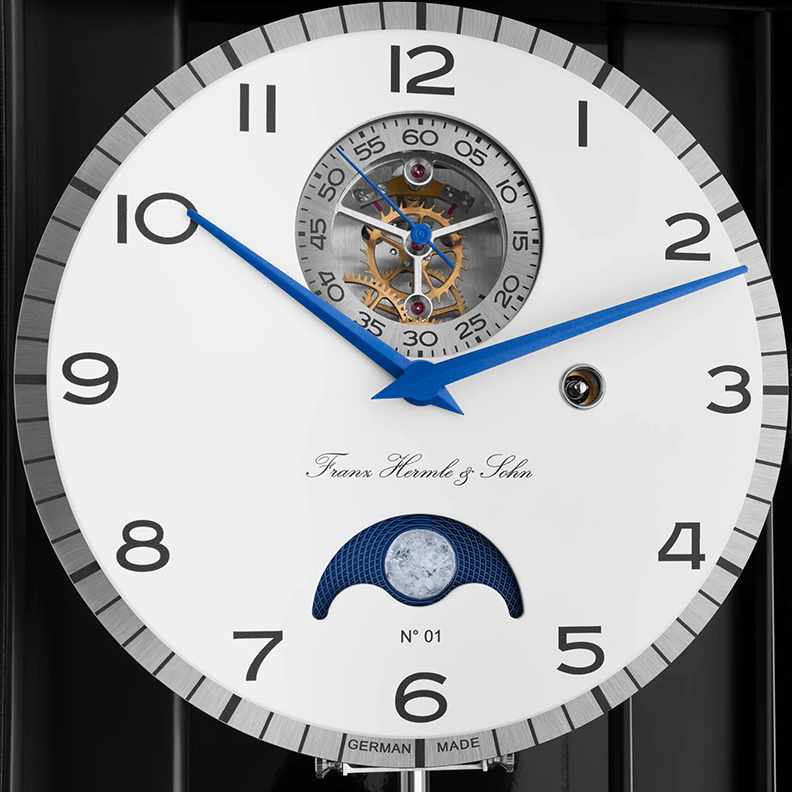 Close-up of a luxury watch face with intricate design and Franz Hermle and Sohn brand name.