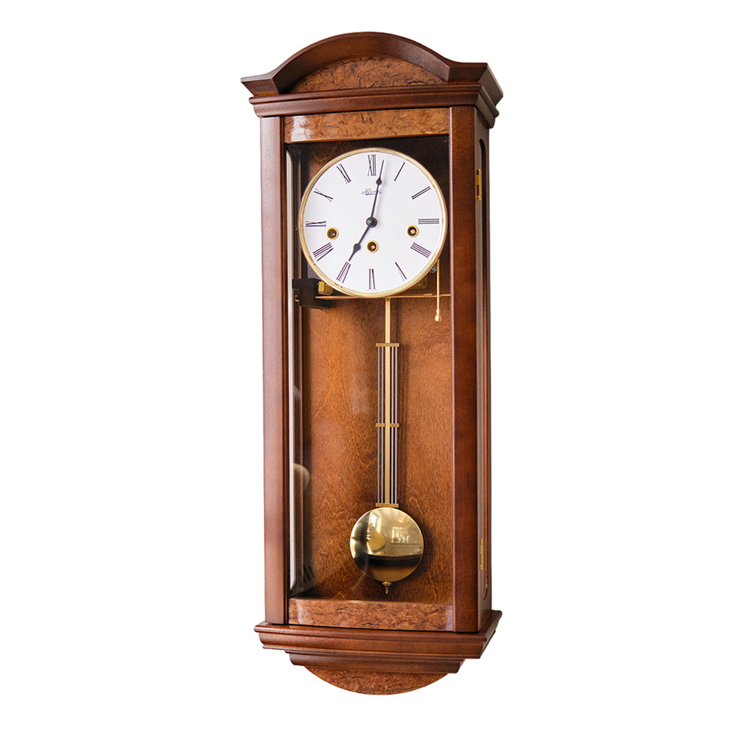 Wooden wall clock with white roman numeral face and brass pendulum