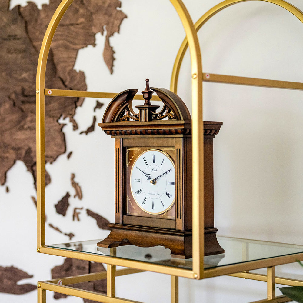 Decorative wooden clock on a glass shelf against a world map background.