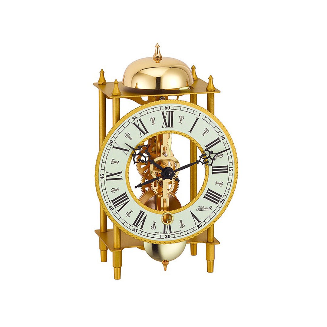 Brass mantel clock with visible intricate gears and roman numeral face on white background