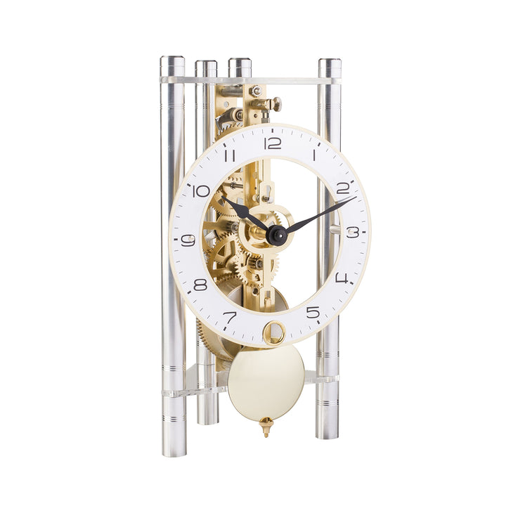 Silver and brass mechanical clock with intricate gears visible on white background